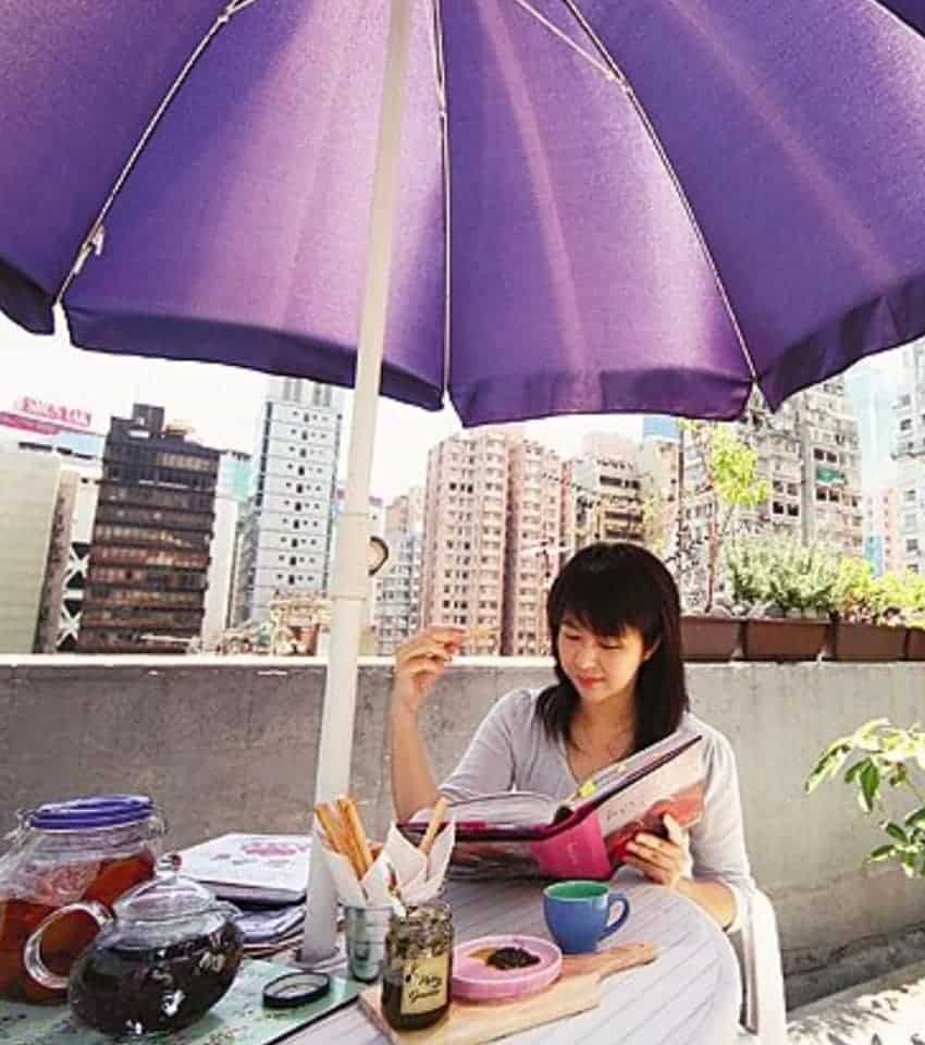 Bonnie Yves is reading cookbook on the roof top